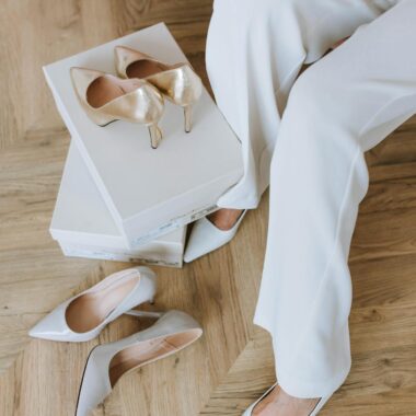 Close-up of a woman trying on elegant high heels indoors.